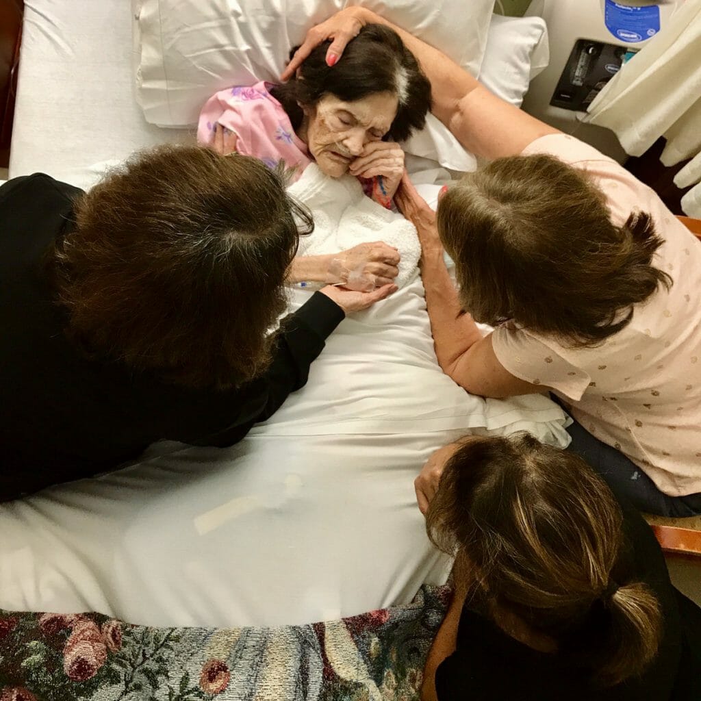 sisters beside bedside of mother